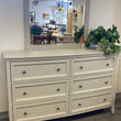 Gray dresser and bevelled mirror