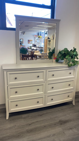 Gray dresser and bevelled mirror